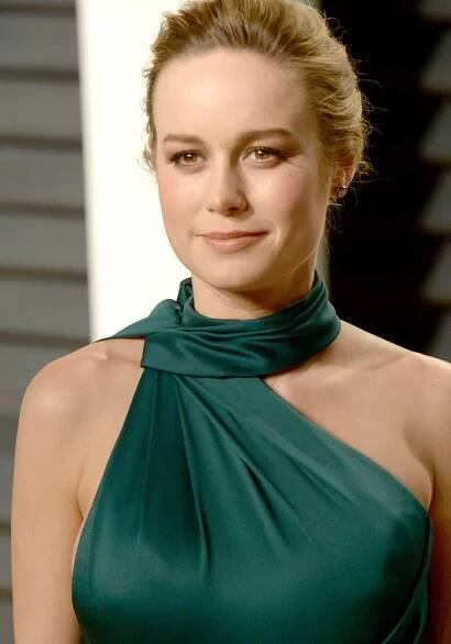 Brie Larson radiates elegance in an emerald green Ralph & Russo gown, showcasing a sleek updo and natural makeup