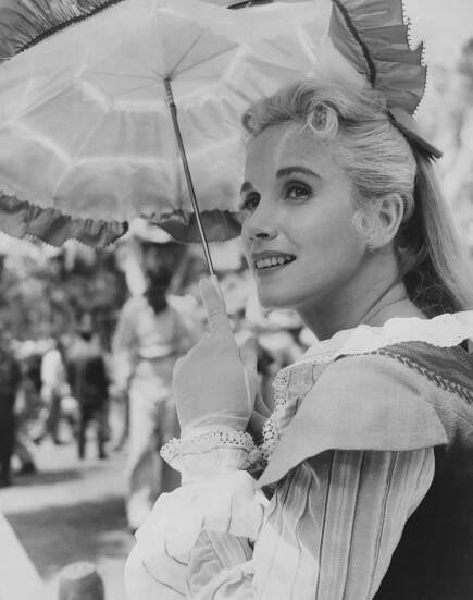 American actress Eva Marie Saint, in costume as she shades herself beneath a parasol during a break in filming of the historical romance 'Raintree County', Kentucky, 1957. Saint plays Nell Gaither in the film adapted from the novel by Ross Lockridge Jr, directed by Edward Dmytryk. 