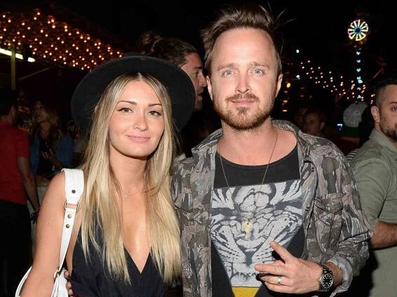 Aaron Paul (R) and Lauren Parsekian attend the Neon Carnival with PacSun, "Dope the Movie and Tequila Don Julio at the Thermal Hangar on April 11, 2015 in Thermal, California.