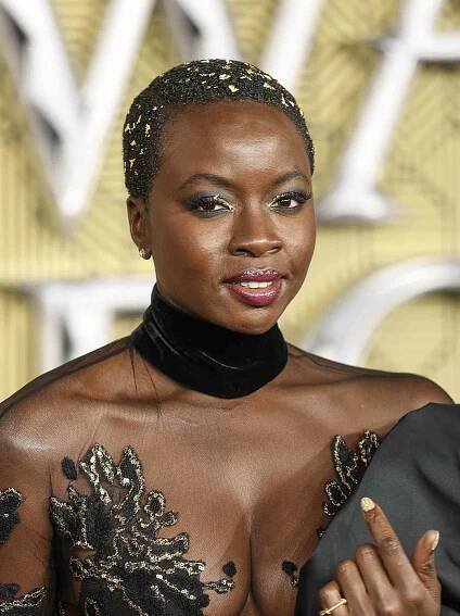 Danai Gurira attends the "Black Panther: Wakanda Forever" European Premiere in gold-flecked buzz cut and black illusion gown