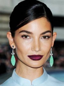 statement earrings hairstyles: woman with sleek side parted hair