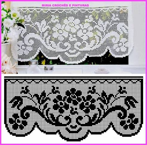a white and black lace curtain with flowers on it