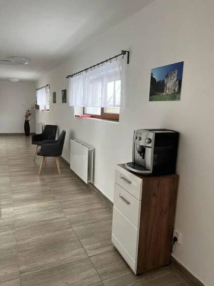 a living room with a tv on a counter with a microwave at Apartmány Nová duha Vavřinec in Vavřinec