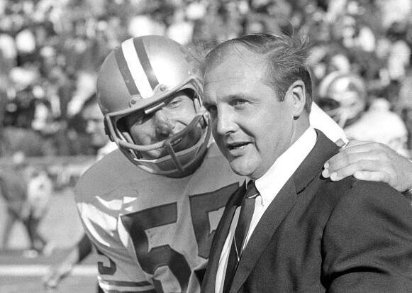 Detroit Lions coach Joe Schmidt and Wayne Walker hold close conference as they watch Detroits offense move against the Green Bay Packers at Green Bay, Sept. 29, 1968. Detroit won, 23-17.