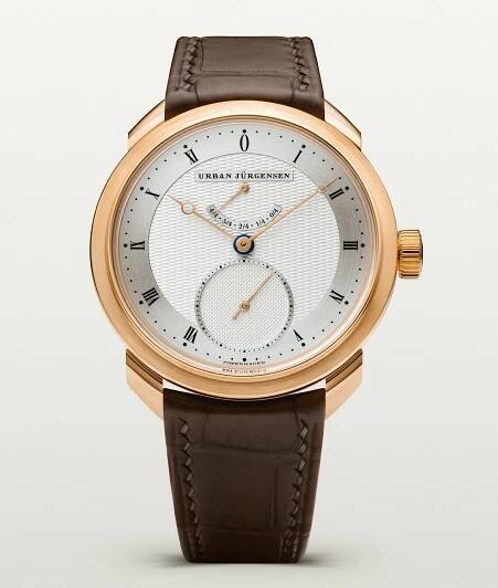 A wristwatch with a brown strap, a gold-colored bezel and a round face, featuring Roman numerals and gold-colored hands.