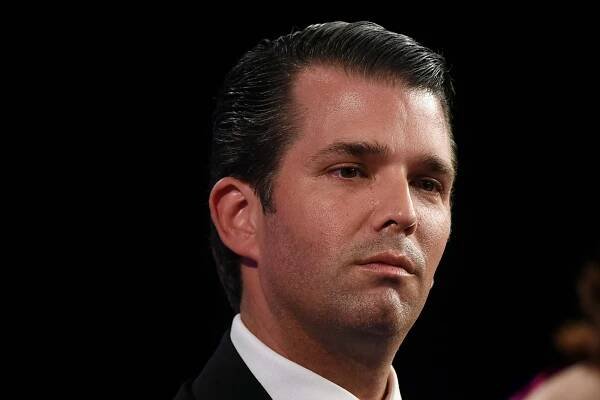 Donald Trump Jr. in a suit looking a little dazed.