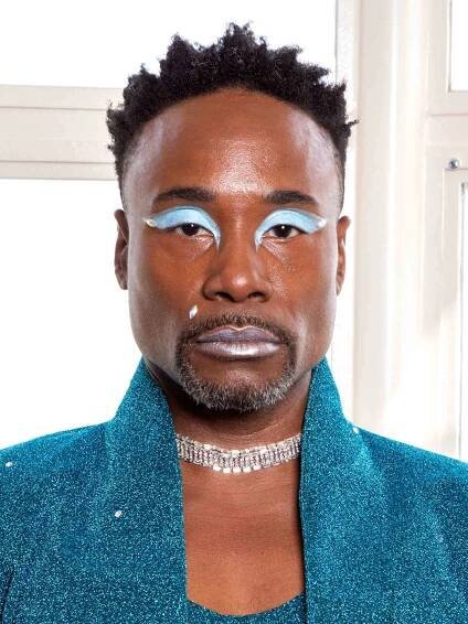 Billy Porter wearing a glittery blue suit, diamond necklace, and baby blue eyeshadow