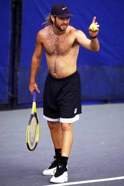 Tennis Legend Andre Agassi Posing Shirtless With a Black Cap Wallpaper
