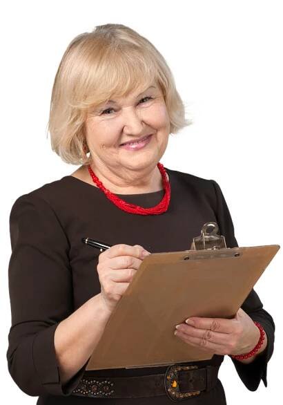 A woman is smiling while holding a clipboard and a pen.