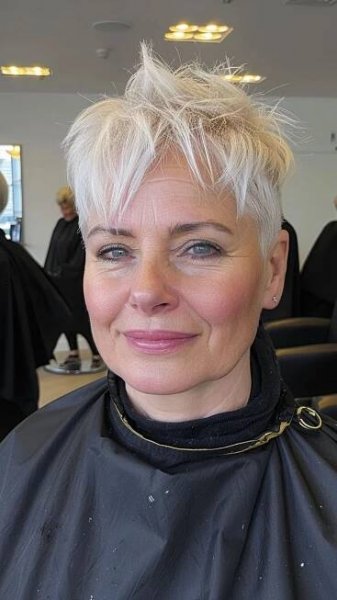 An old woman modelling a platinum blonde pixie cut.