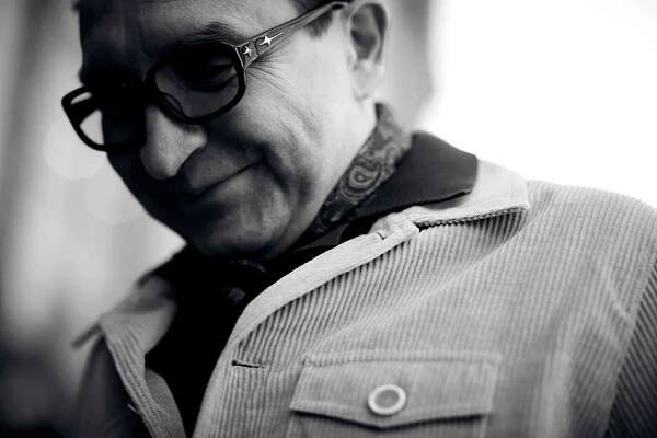 Eddie wears jacket by Oliver Spencer, and t-shirt by Oliver Spencer.