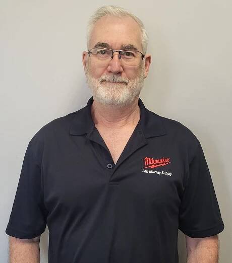A man with a beard and glasses is wearing a black shirt that says milwaukee on it