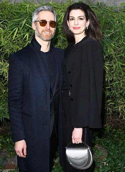 Adam Shulman and Anne Hathaway are seen on the front row of the Giorgio Armani fashion show during the Milan Fashion Week Fall/Winter 2022/2023 on February 27, 2022 in Milan, Italy.