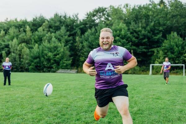 Rugby player running on a field
