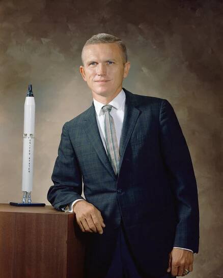 Portrait of astronaut Frank Borman with model shuttle