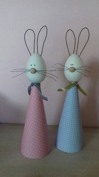 two plastic rabbits are standing next to each other