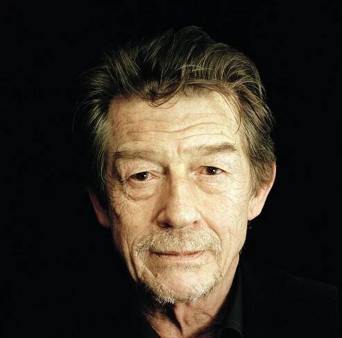 Close-up portrait of John Hurt against a black backdrop Wallpaper