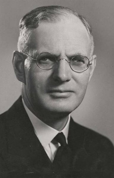 Portrait photograph of a middle aged man with glasses. - click to view larger image