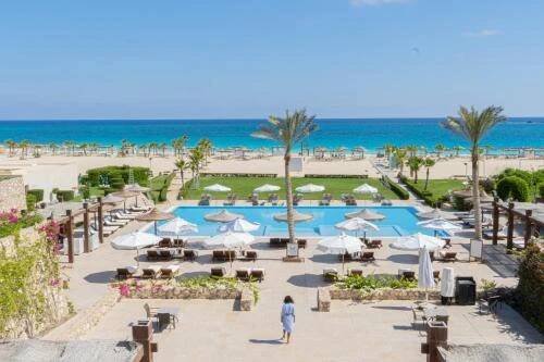 a view of a resort with a pool and the beach at Caesar Bay Resort in Marsa Matruh