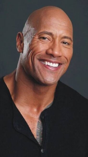 the rock smiling and wearing a black shirt