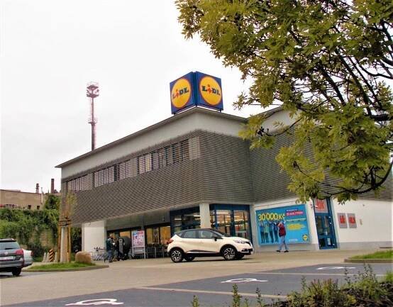 a store with a car parked in front of it at soukromý pokoj in Prague
