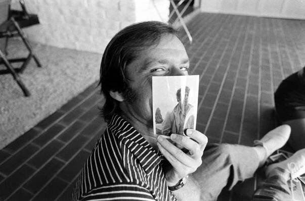 Jack Nicholson clowned around at his home with a picture of his friend, the film director Bob Rafelson, Los Angeles, 1969.
