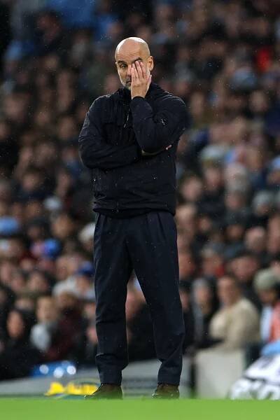 Pep Guardiola, Manchester City manager, looking dejected.
