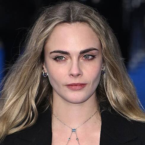 Cara Delevingne's thong is on full display in plunging see-through mesh maxi dress that is peak indie sleaze