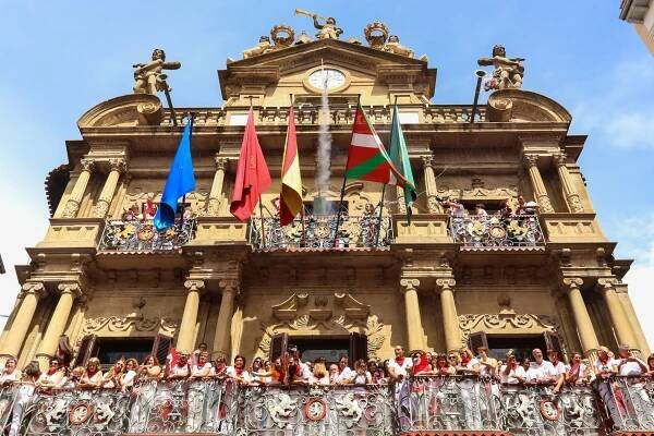  On July 6th, 2017 people gather at Pamplona's city council offices to watch the rocket explodes that officially marks the beginning of the San Fermin Festival.  