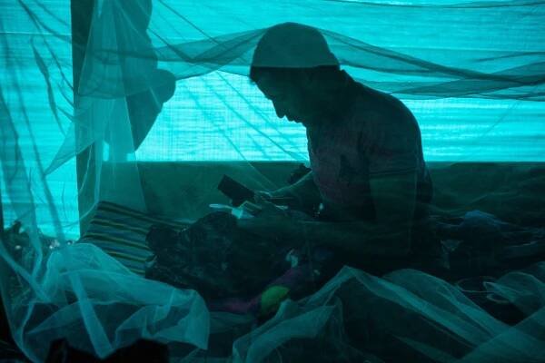 Jorge Blanco Escobar preparing his belongings inside his barrack at the expedition camp.