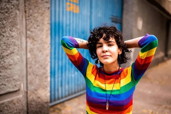 Portrait smiling woman rainbow sweater