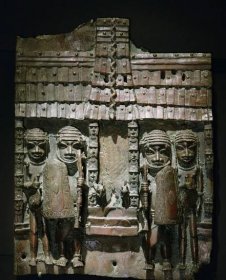 A Benin bronze plaque, showing a python crawling down a tiled roof, and four male figures on either side of a column. 