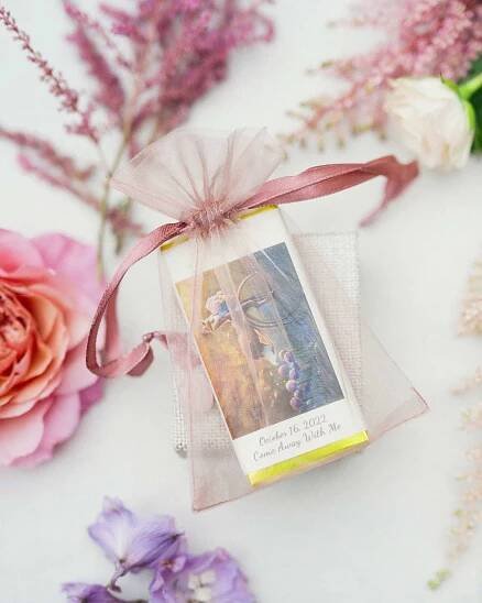 Anika Noni Rose and Jason Dirden's Chocolate Bar Wedding Favor in Pink Bag with Flowers Around