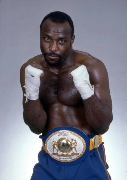 Dwight Muhammad Qawi, formerly Dwight Braxton, posing with fists raised and championship belt.