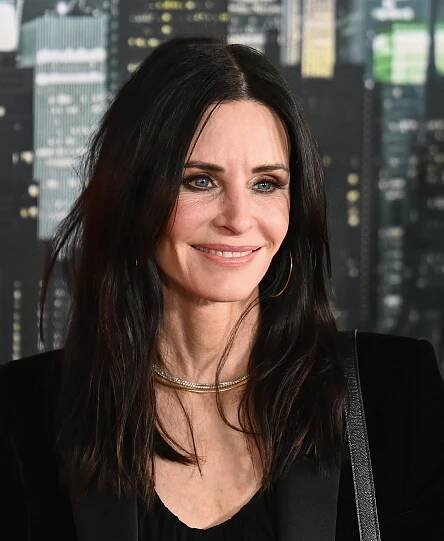 Courteney Cox smiling at an event