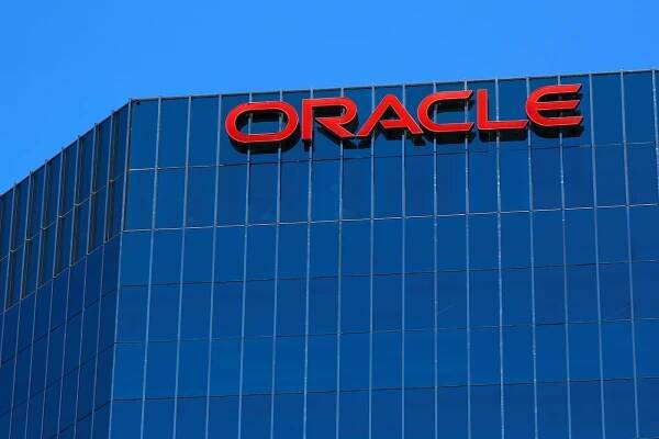 The Oracle logo is shown on an office building in Irvine, California