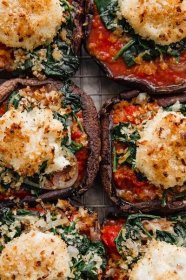 AMAZING Stuffed Portobello Mushrooms topped with marinara sauce, spinach, and crispy goat cheese. A DELICIOUS and easy vegetarian main course! #goatcheese #vegetarian #portobellomushrooms #stuffedmushrooms #spinach #marinara #abeautifulplate