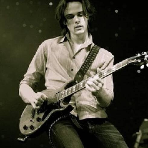 Paul Allen Playing Guitar Strings
