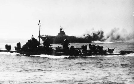 80-G-328441: Operation Ten-Go, USS Intrepid (CV-11), April 16, 1945. USS Intrepid (CV-11), hit by Japanese suicide plane. Taken from USS Alaska (CB-1), 16 April 1945. 