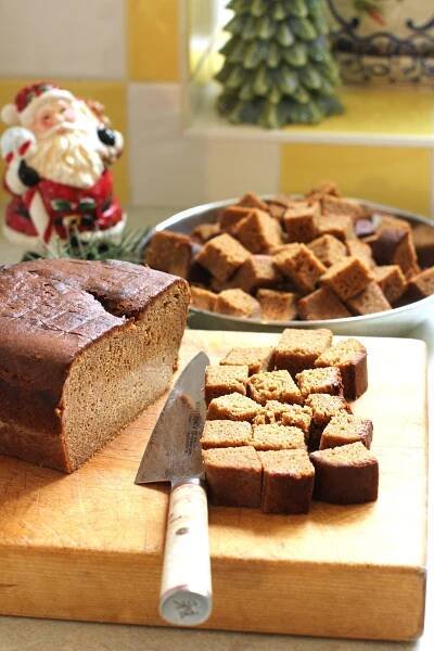 cutting cubes of Lebkuchen loaf on the cutting board.