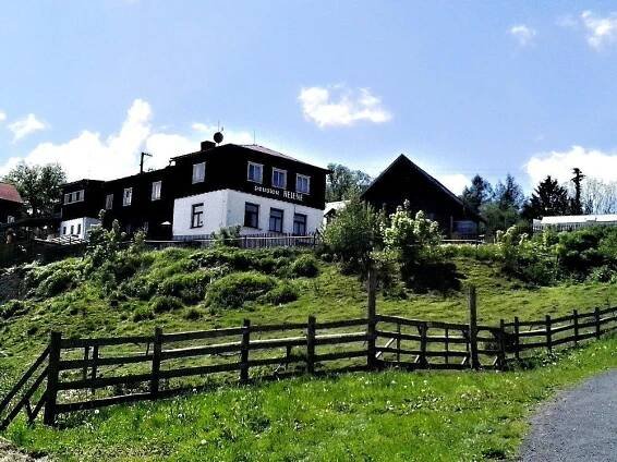 a house on top of a hill with a fence at Pension Helene s mini pivovarem in Kytlice