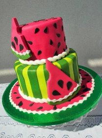 a watermelon themed cake is sitting on a table