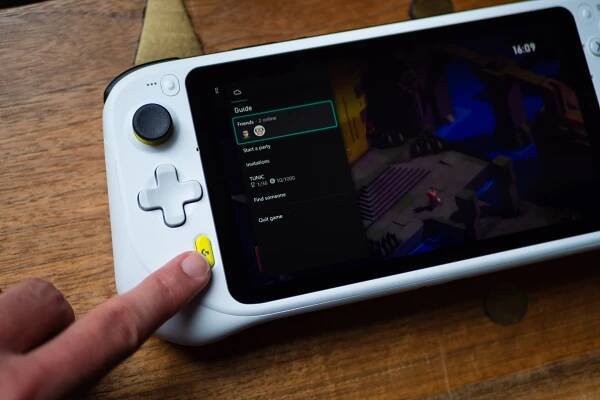 The Logitech G Cloud Gaming Handheld displaying the Xbox Cloud Gaming app. The author is pressing a yellow G button, which activates the Xbox menu in the app.