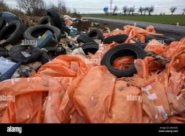 Illegal dumping of used tires discarded at county road, Czech Republic Stock Photo