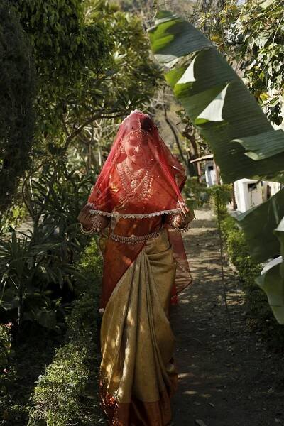 A woman in a sari walking down a path