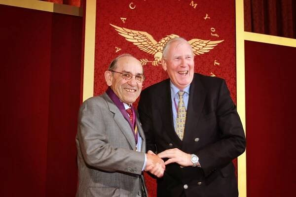 Baseball Hall of Famer Yogi Berra is inducted into the Academy by track and field legend Sir Roger Bannister. 
