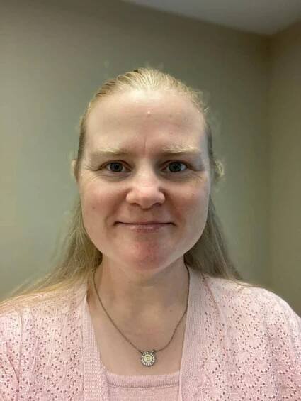 Elizabeth Hoffman smiling while taking a photo.