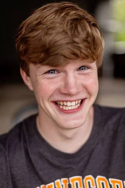 Teen boy posing silly and laughing during senior pictures with MegMc Photography at Crown Winery in Humboldt, TN