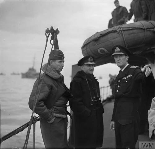 dmiral Ramsay (centre) with Sir Arthur Tedder (left) and Rear Admiral Sir Philip Vian (pointing) on board HMS KELVIN.