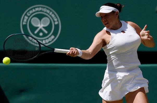 Amanda Anisimova reacts during a Wimbledon tennis match.